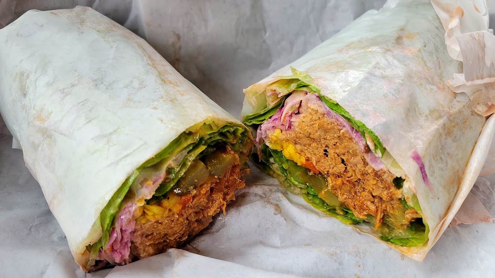 A loaded wrap rolled to order with seasoned filling, red cabbage and lettuce