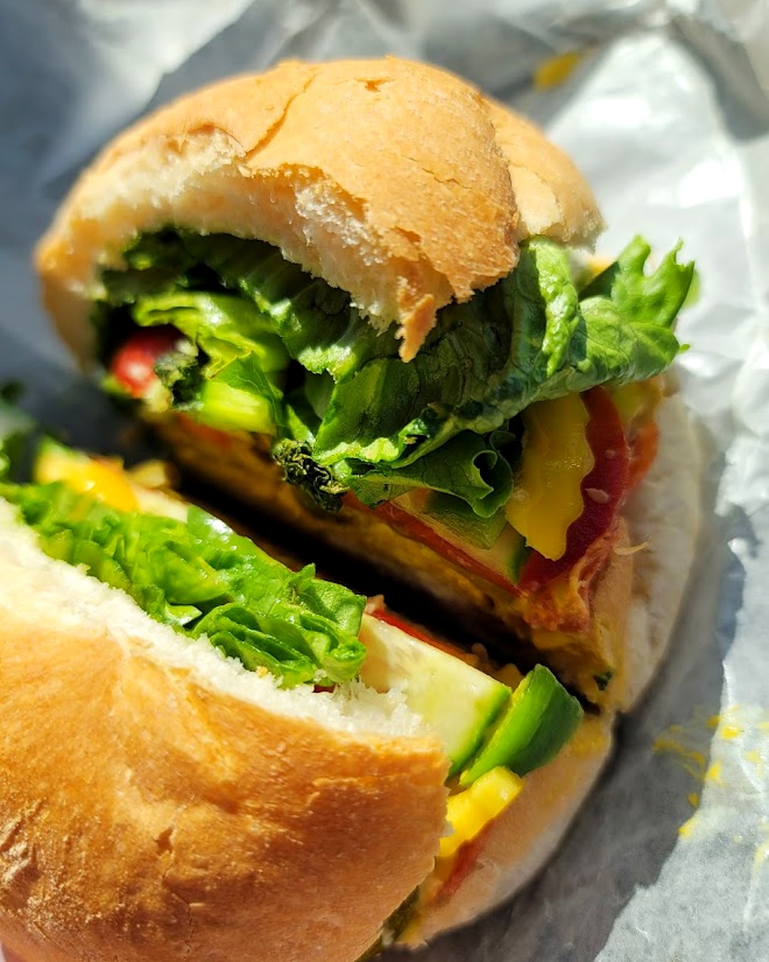 Piled-high veggie sub on a fresh-baked kaiser roll with avocado, lettuce, tomato and cheese