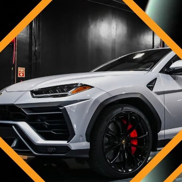 A white Lamborghini Urus in the JK Motors service bay